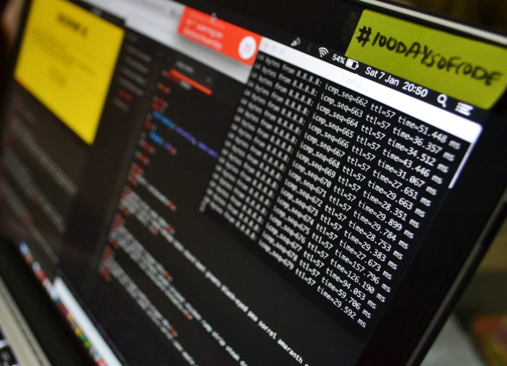 Monitor screen with ping results and green sticker with black writing.